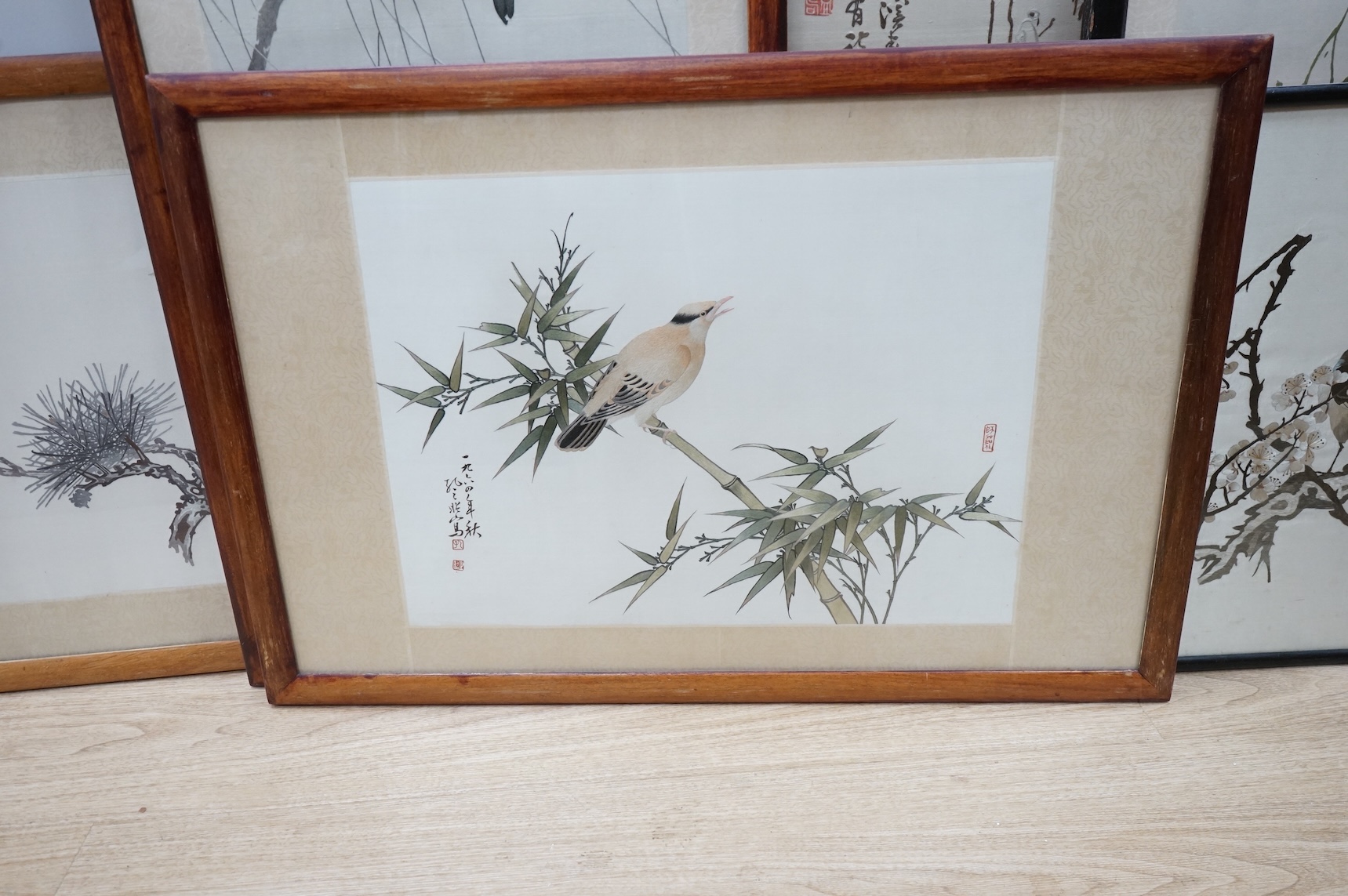 Seven Chinese embroideries on silk, mountainous landscapes and birds, largest 121cm high